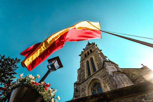 Flag Waving Above Entrance St. Florin Cathedral In Vaduz, Liechtenstein