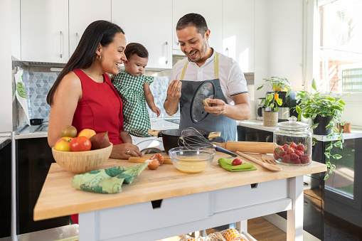 latin family cooks in the kitchen.