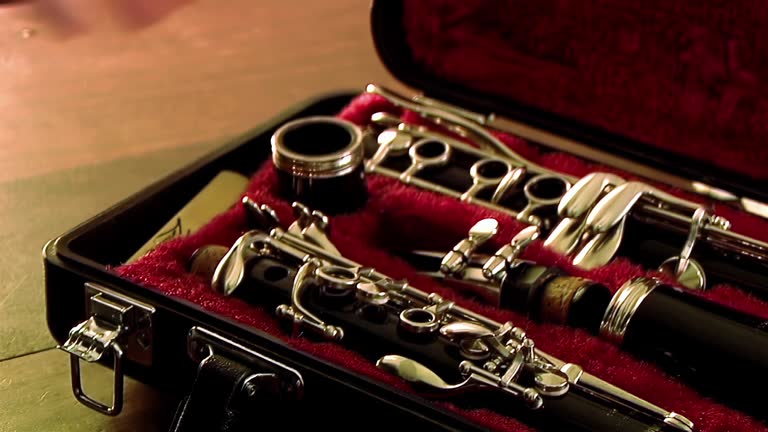 Hands of a Young Man Opening the Case of a Clarinet, Disassembled Clarinet in its Case. 4K Resolution.