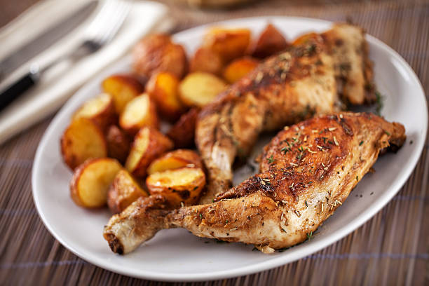 istock Roast chicken with potatoes on a plate 163001904