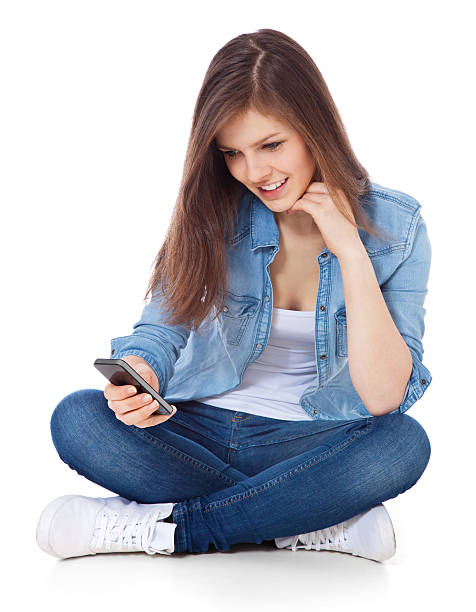 Teenage girl using smart phone stock photo