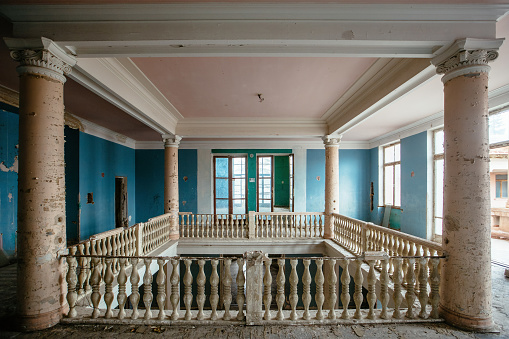 Large entrance hall with columns in old abandoned mansion, Sanatorium Gelati, Tskaltubo