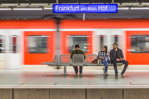 Frankfurt, Germany - March 29 2014: people waiting for S-Bahn in Frankfurt local train station. The electrified S-Bahn serves the Rhine-Main area with local transportation.