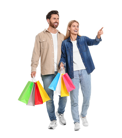 Family shopping. Happy couple with many colorful bags on white background