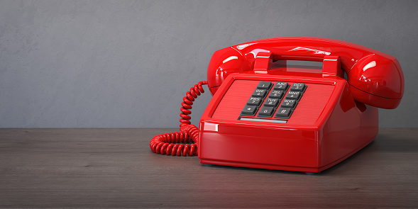 Red telephone on a wooden table. 3d illustration