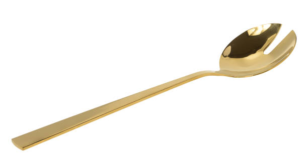 istock Golden spoon for stirring salad on white isolated background 1630045420