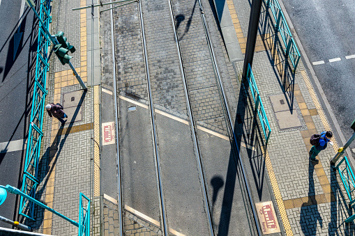 Cologne, Germany - February 12, 2014: aerial of streetcar stop with waiting passenger.