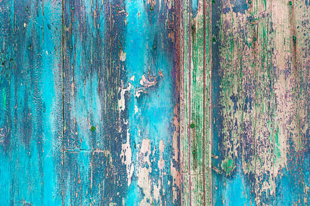 close-up of a wooden panel texture close-up of a wooden panel texture - Old wooden board background painted in many colors rustic door stock pictures, royalty-free photos & images