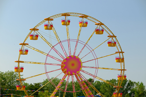 Stuttgart Bad Canstatt, Germany - October 11, 2019: View of ferris wheel of folk festival, amusement ride against sky in blue. Stuttgart, Germany