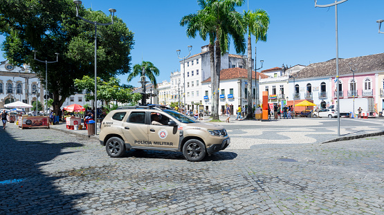 Salvador, Bahia, Brazil - August 19, 2023: A Bahia military police car passing by Terreiro de Jesus square in Pelourinho, Historic Center of the city of Salvador. Bahia Brazil.