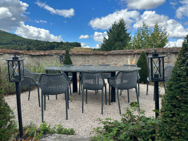 istock Beautiful terrace with table, chairs and old stone walls 1630133604