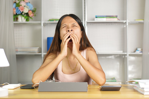 woman working at home have drowsiness