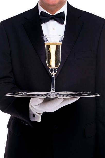 butler sirve una copa de champán - waiter butler champagne tray fotografías e imágenes de stock