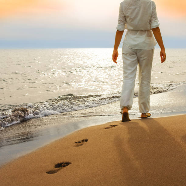 istock Woman Walks Along The Beach 163017116