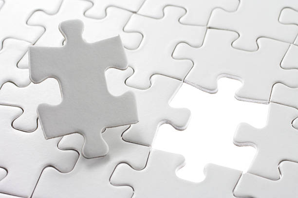 istock Unfinished jigsaw puzzle and last piece. 163017411