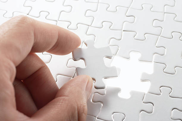istock Person matching the last puzzle pieces. 163018566