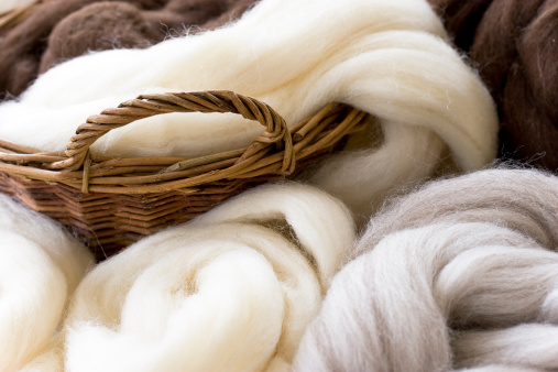 Natural wool fibres in basket, shallow DOF.