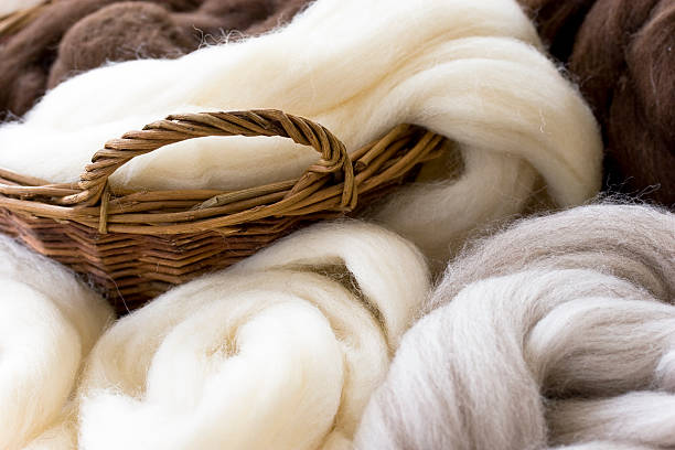 New  wool in natural colors Natural wool fibres in basket, shallow DOF. wool stock pictures, royalty-free photos & images