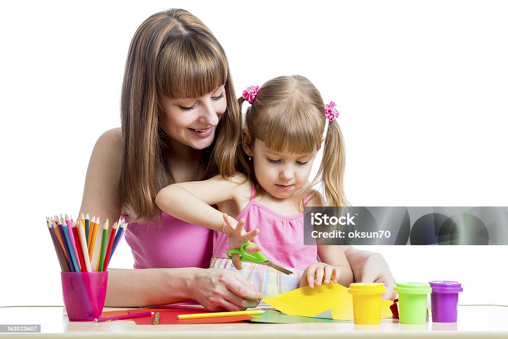 Mother teaches preschooler kid to do craft items. DIY concept. Child Stock Photo