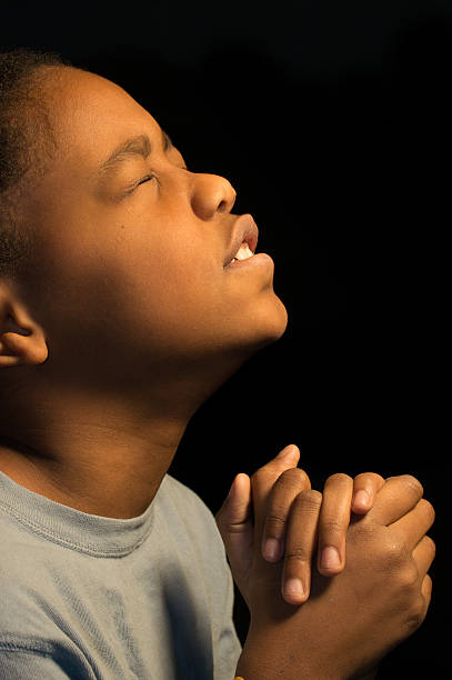 istock Praying African Americn boy 163023638