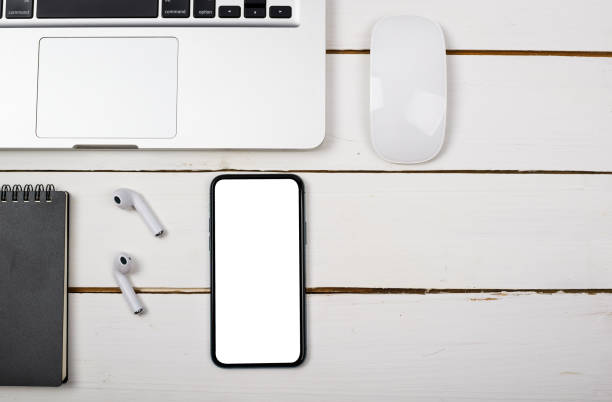 istock Smartphones and laptops on white wooden desks 1630246002