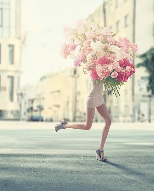 Photo of running women with giant bunch of flowers