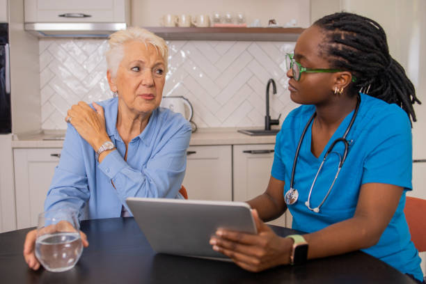 istock Nurse helping senior woman 1630265706