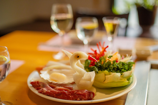 table setting japanese teppanyaki restaurant. fresh figurative vegetables and glasses of wine