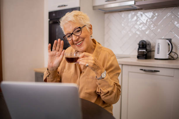istock Happy senior woman using digital tablet 1630267302