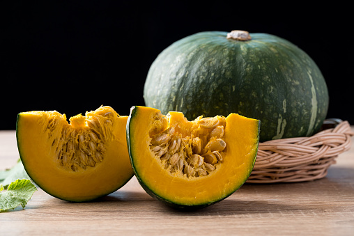 Green pumpkin on wooden with black background, Organic vegetable in autumn season