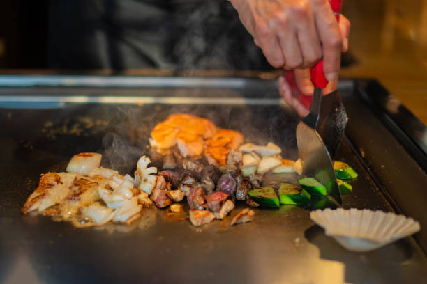 istock Chef cooking in Japanese teppanyaki restaurant 1630274677