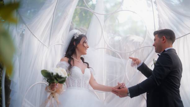 istock Bride and groom dancing together 1630308659