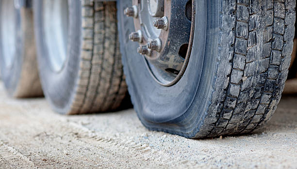 Flat Tire on a Semi Trailer Flat tire on a semi trailer flat tire stock pictures, royalty-free photos & images