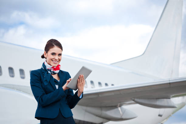 Beautiful air stewardess with digital tablet