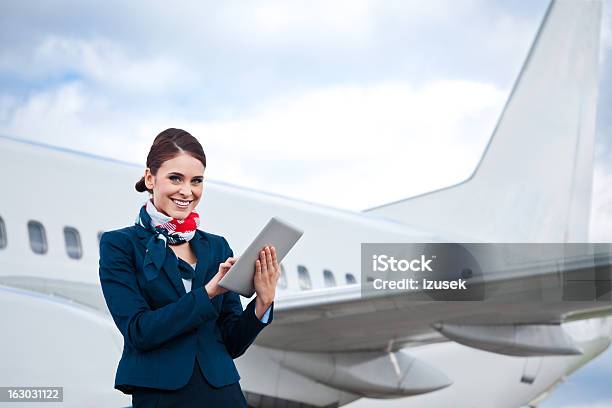 Beautiful Air Stewardess With Digital Tablet Stock Photo - Download Image Now - Air Stewardess, Digital Tablet, Portrait