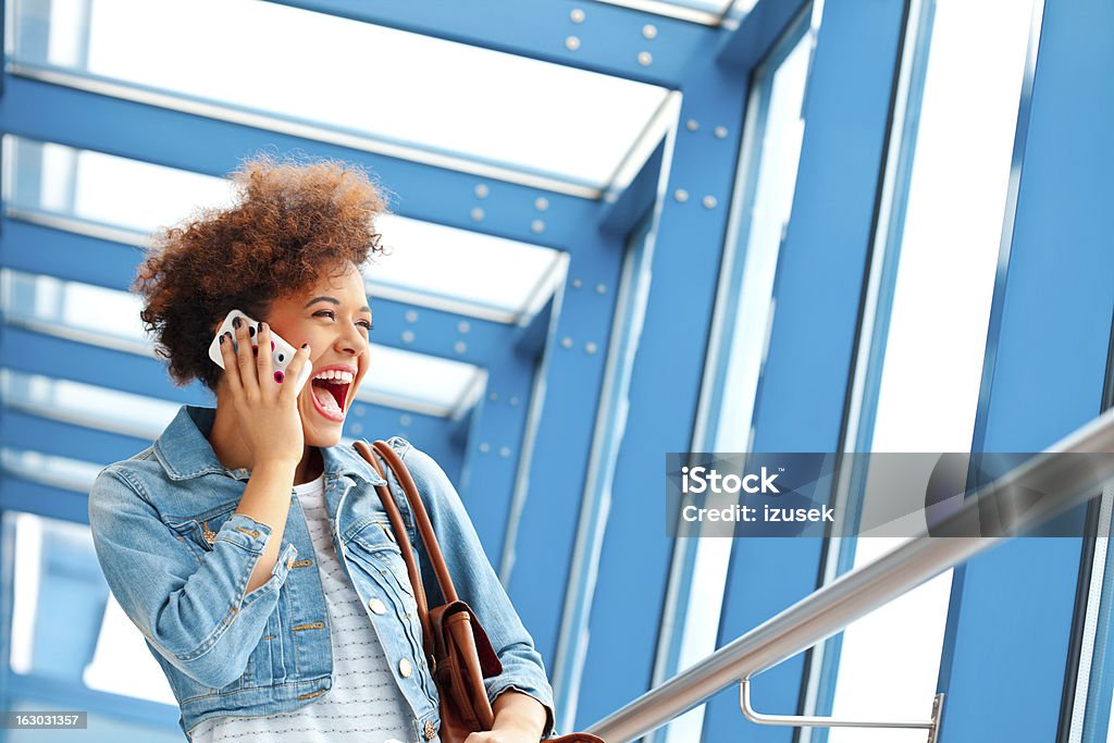 Happy teen girl with mobile phone Portrait of excited teenaged girl talking on mobile phone. Ecstatic Stock Photo