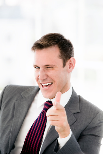 Happy businessman making thumbs up
