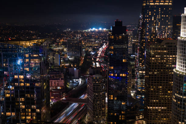istock Downtown LA Towers and Freeway Traffic at Night - Aerial 1630332991