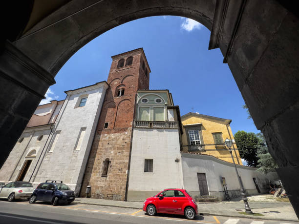 Lucca - buildings and red car through archway stock photo