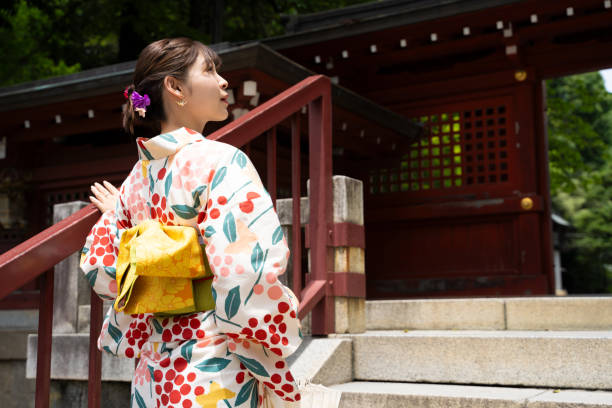 istock A beautiful woman in a yukata strolling around a shrine. 1630349103