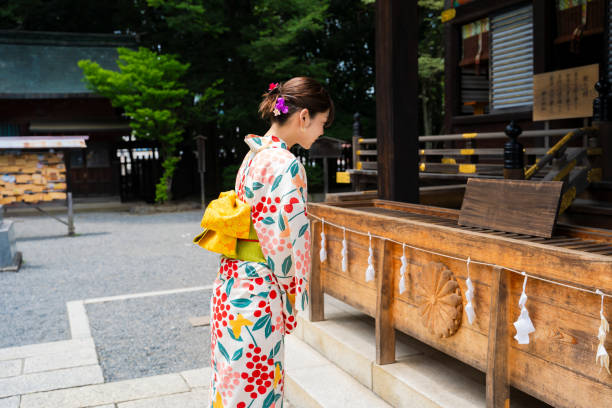 istock A beautiful woman in a yukata strolling around a shrine. 1630350157