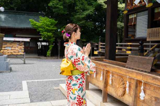 istock A beautiful woman in a yukata strolling around a shrine. 1630350661