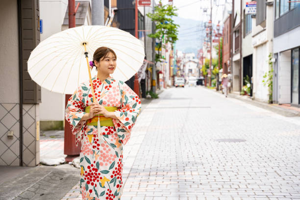 istock A beautiful woman in a yukata strolling around a shrine. 1630351696