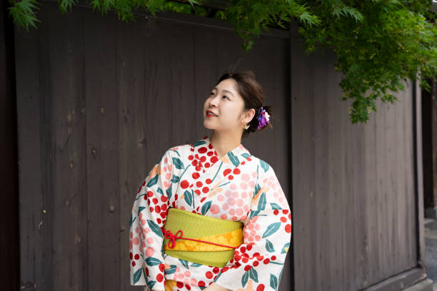 istock A beautiful woman in a yukata strolling around a shrine. 1630351700