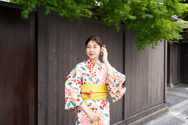 istock A beautiful woman in a yukata strolling around a shrine. 1630351706