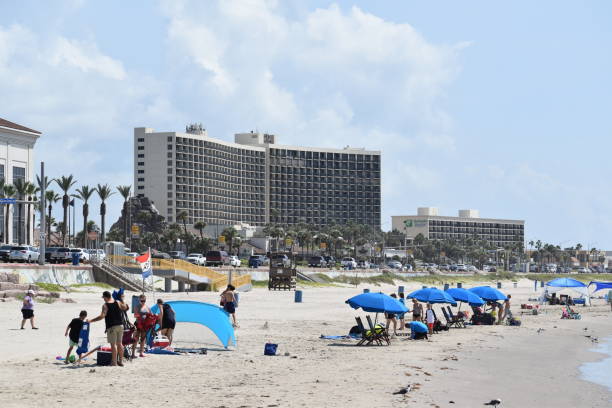 texaner und touristen genießen einen sommertag in rekordhitze am galveston beach - texas blues stock-fotos und bilder