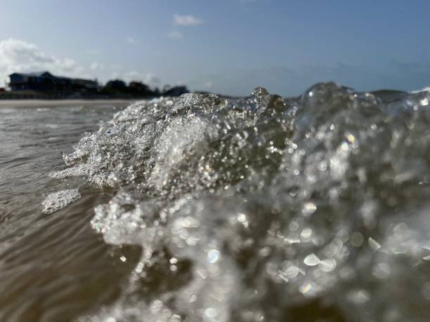 istock Close up view of small wave crashing to shore. 1630394094
