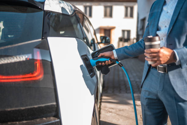 istock Asian Man Charging his Electric Car 1630444535