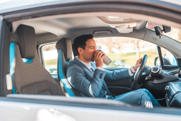 istock Mature Asian Man Drinking Coffee in his Car 1630445055