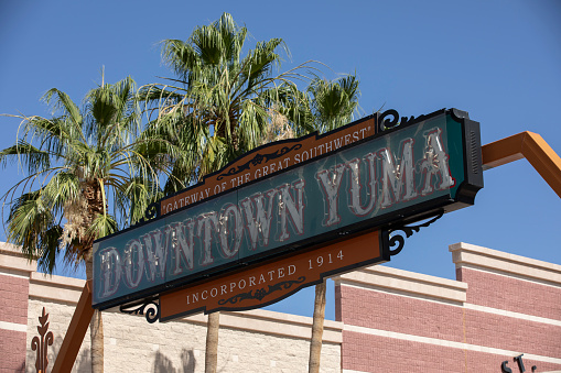 Yuma, Arizona, USA - May 27, 2022: Afternoon sun shines on the historic welcome sign of Downtown Yuma.